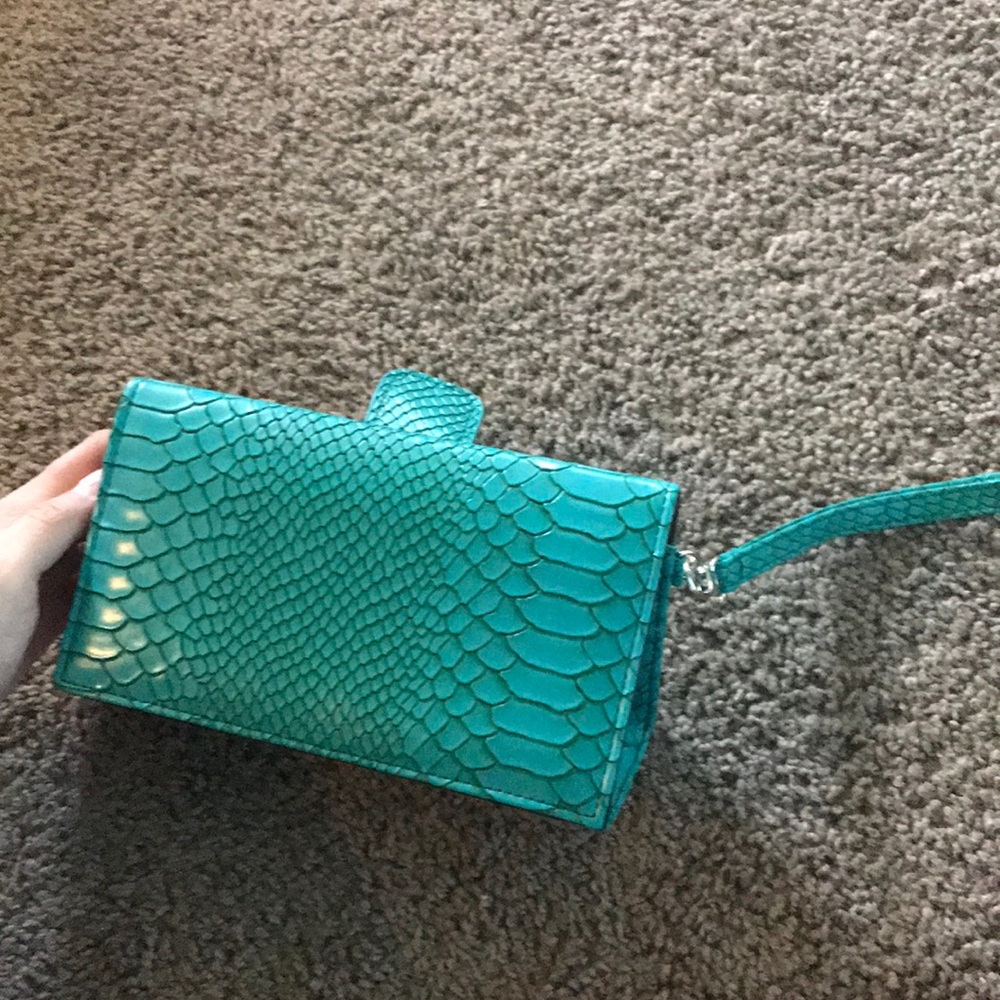 Green handbag with snake patterns